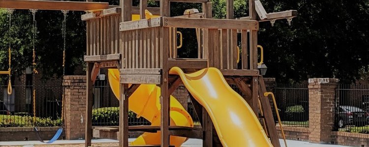A wood unit with 2 slides and swings